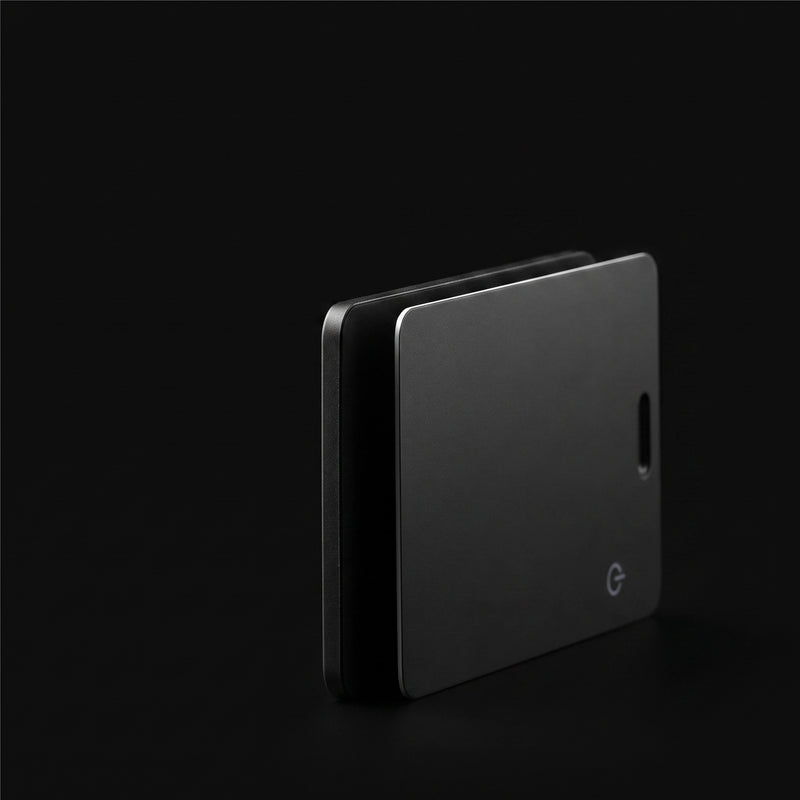 Two LYNK Card Trackers seen edge on, showing how thin the card is and the power button on the face